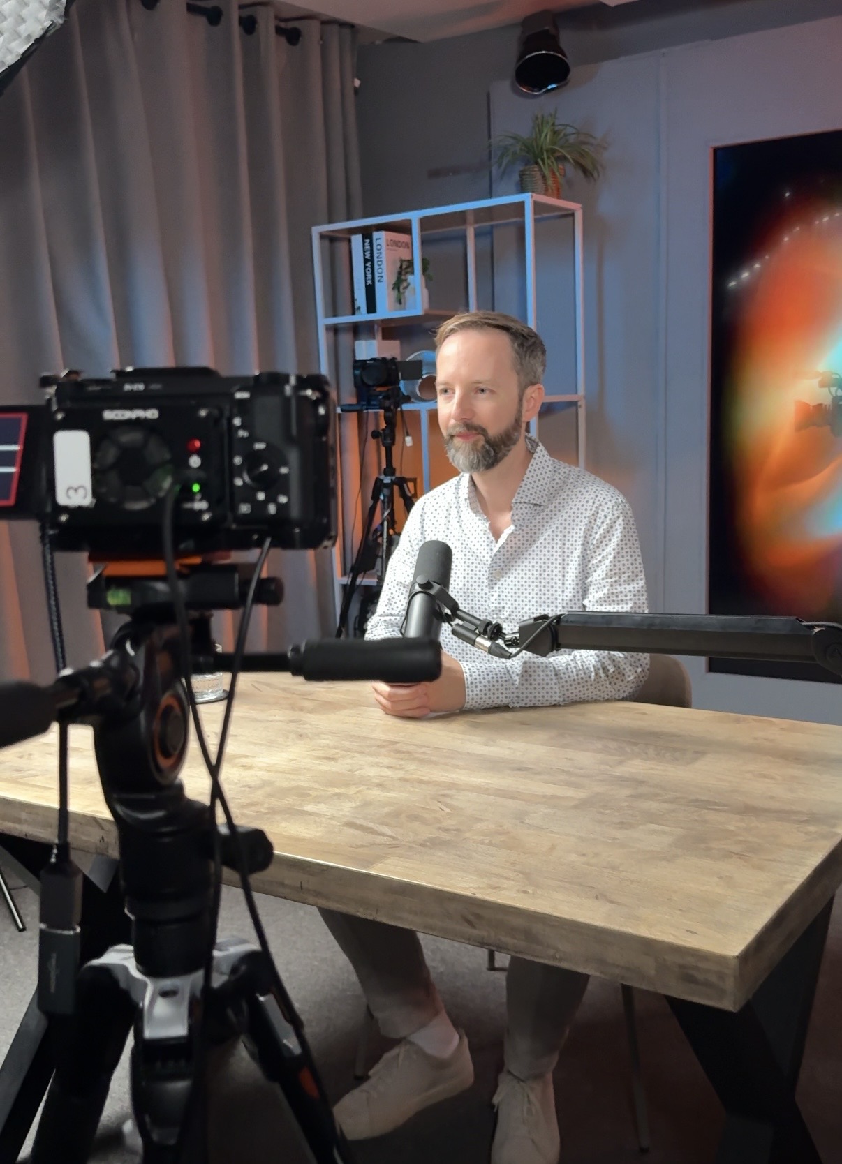 Jackson Kingsley seated at a desk in a video studio